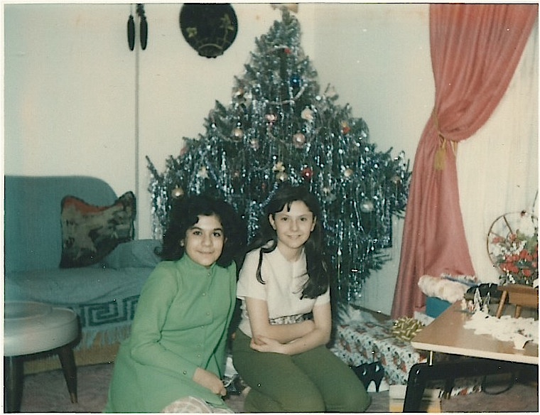 My cousin, Nancy and I sitting under the tree. 