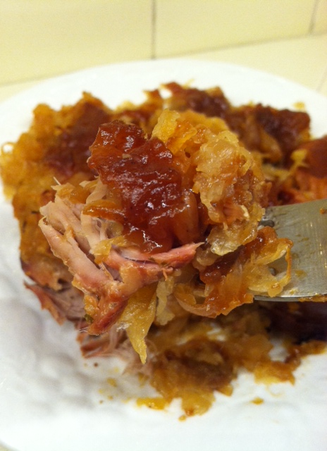 A delicious bite of fork-tender pork and sauerkraut.