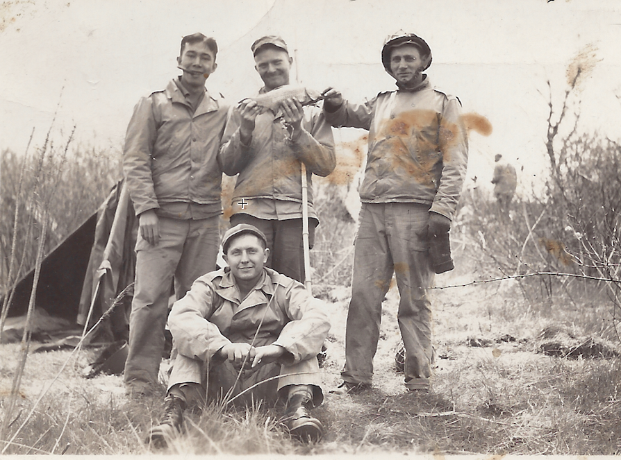 Dad  in front, with Army buddies. I think they're holding a fish.
