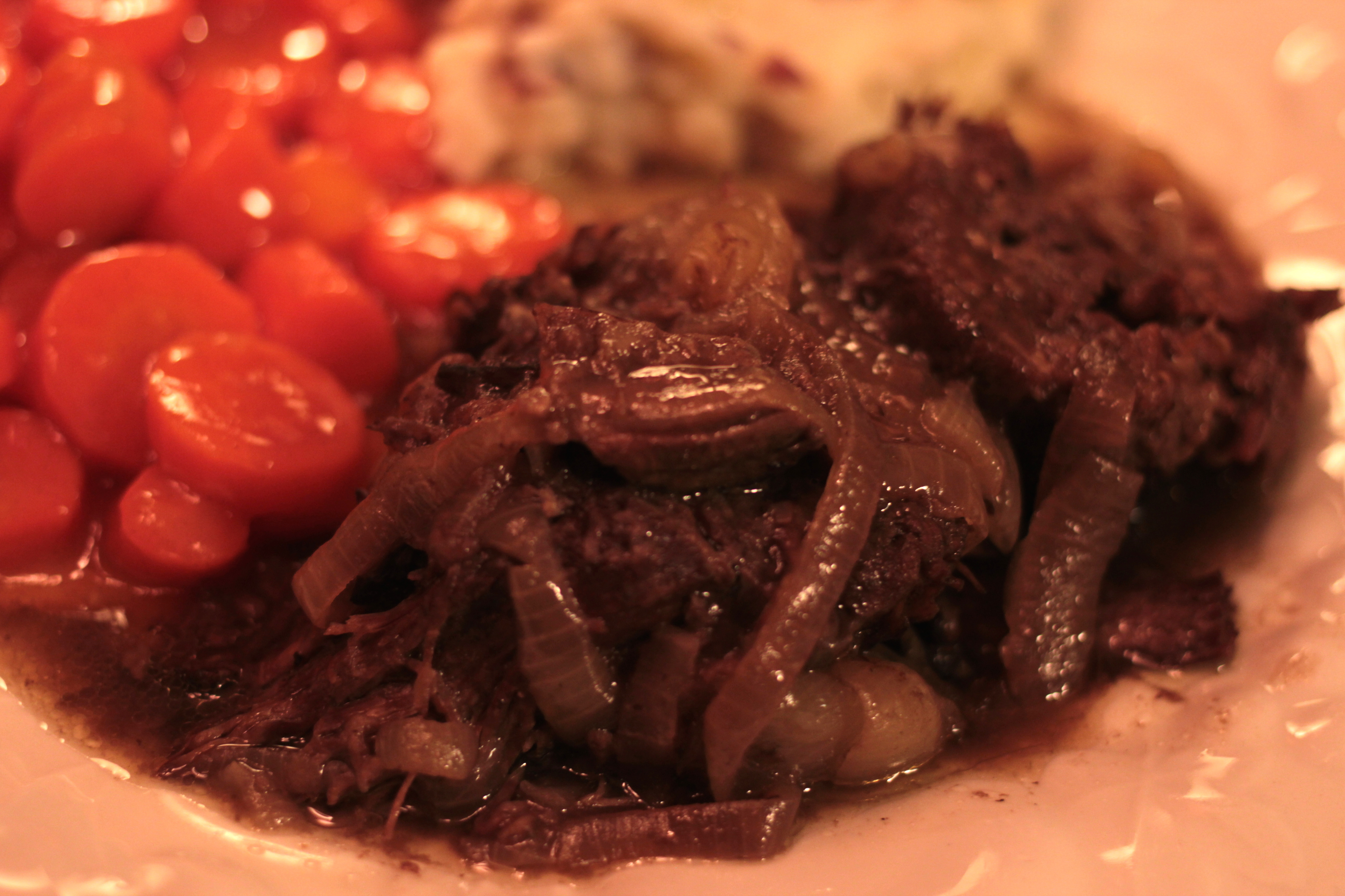 Slow cooked chuck roast with onions and red wine.